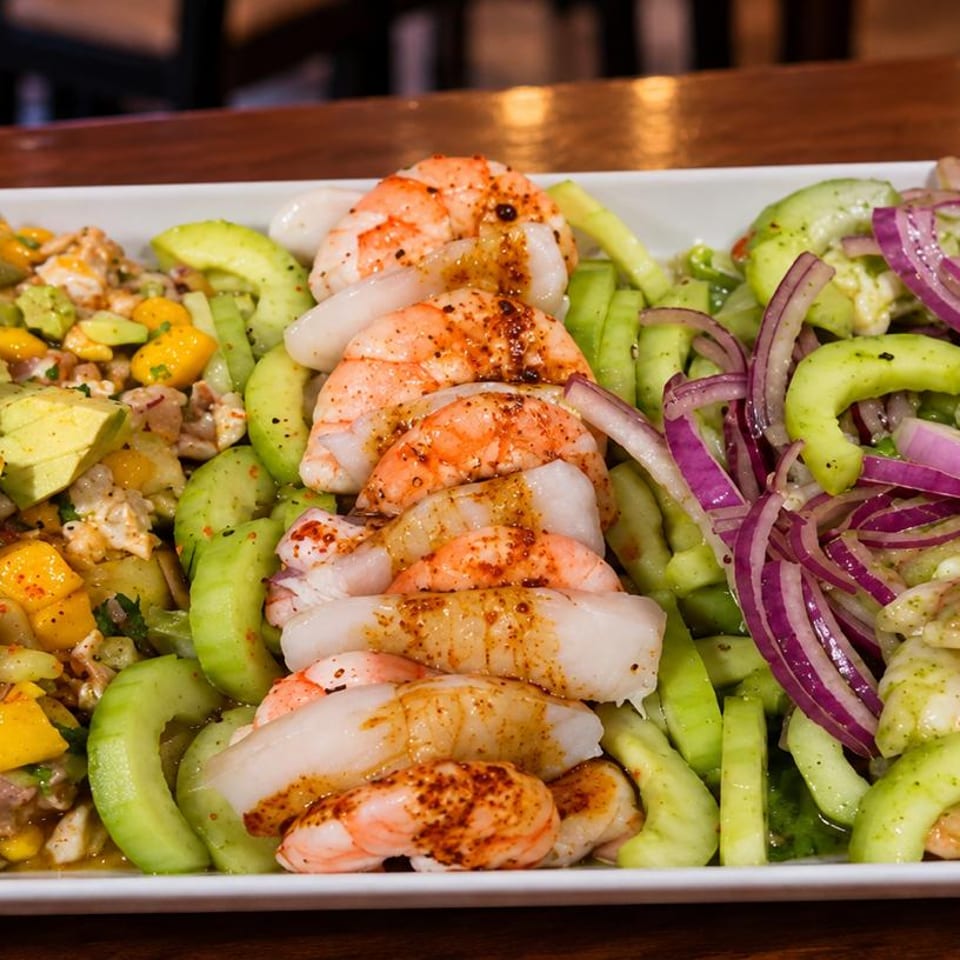 Seafood platter with shrimp, cucumber, avocado, mango and red onion